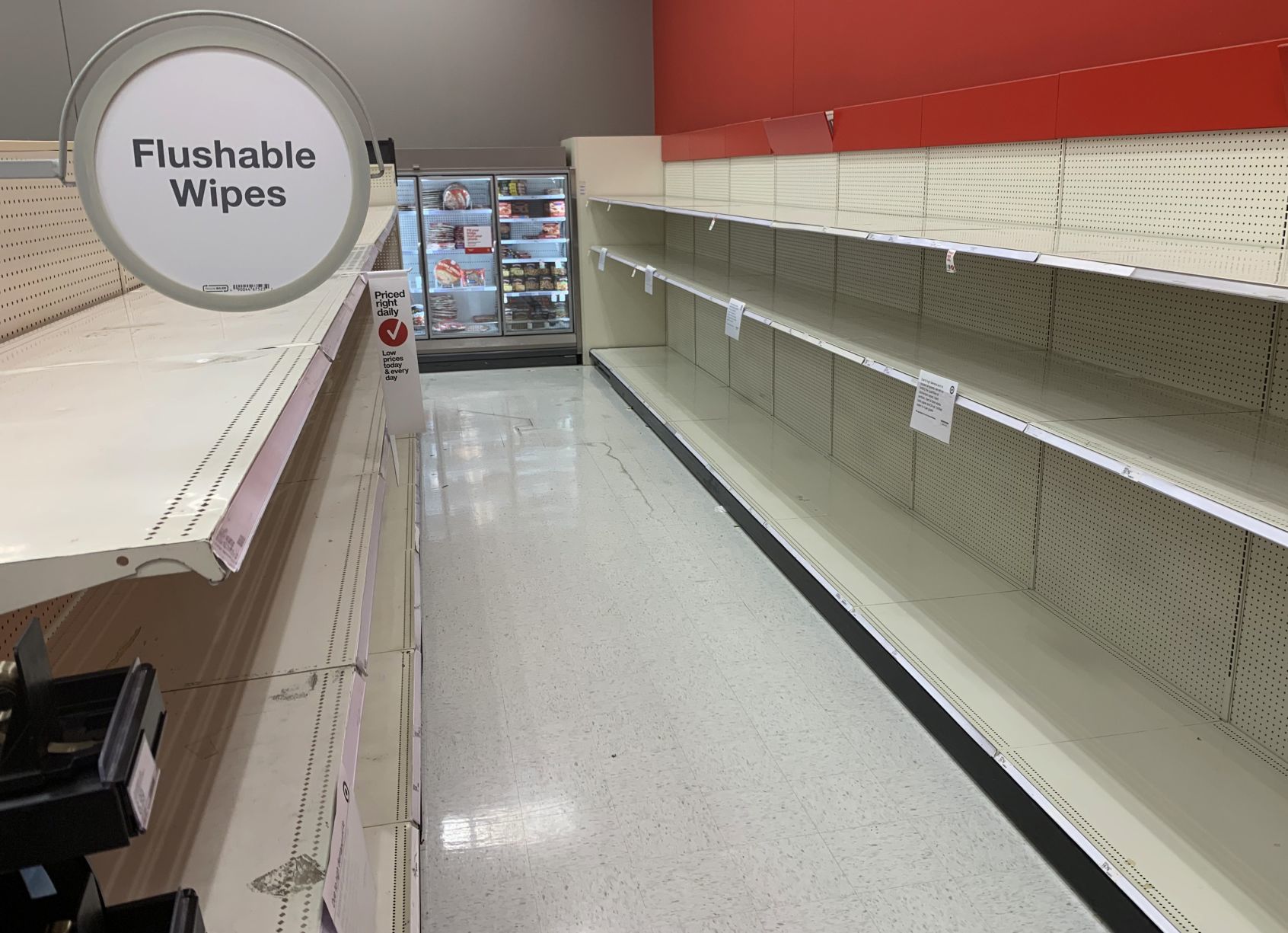 Empty shelves of disinfectatnt wipes, hand sanitizer and toilet paper